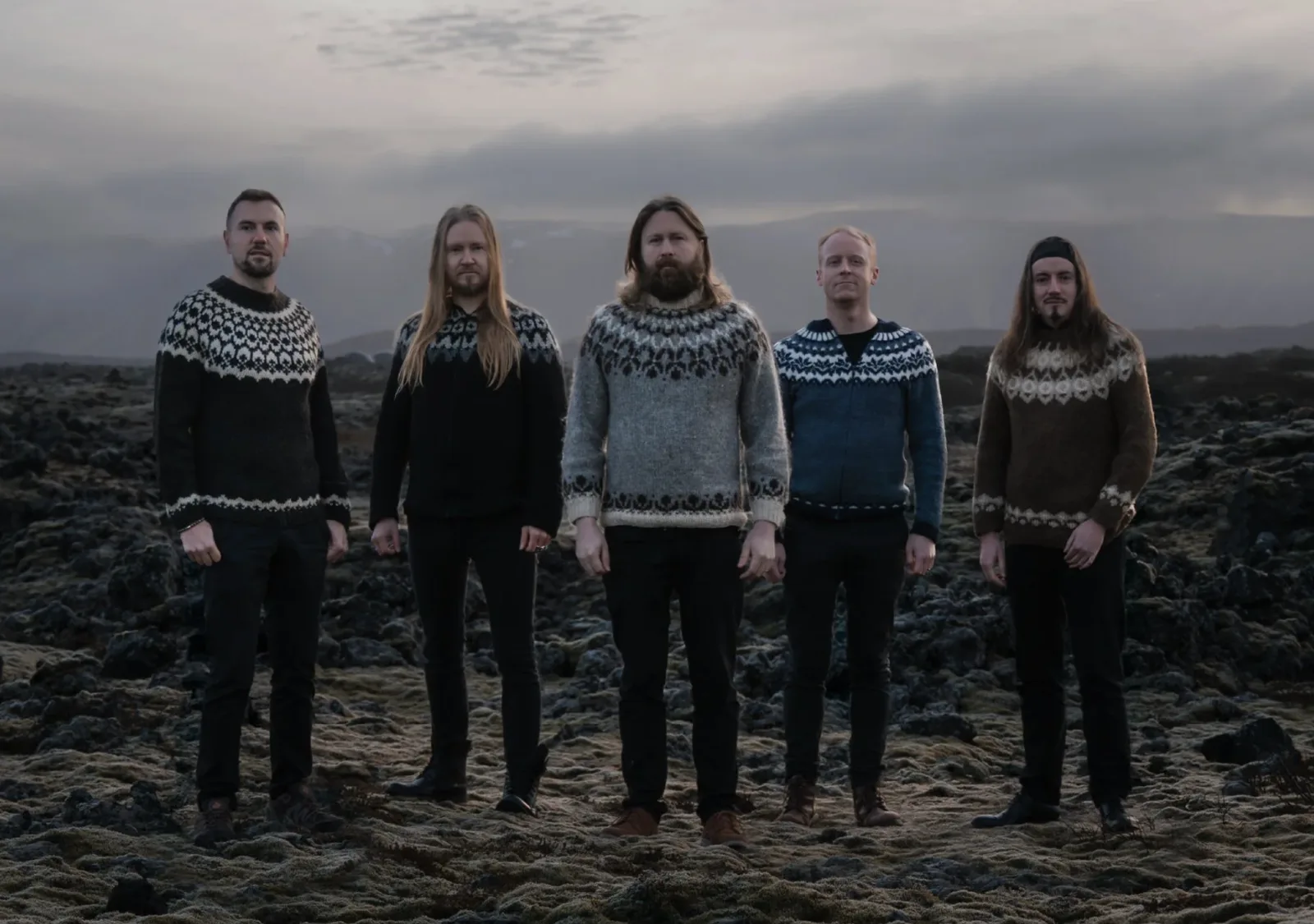 Árstíðir band members standing in an Icelandic lava field