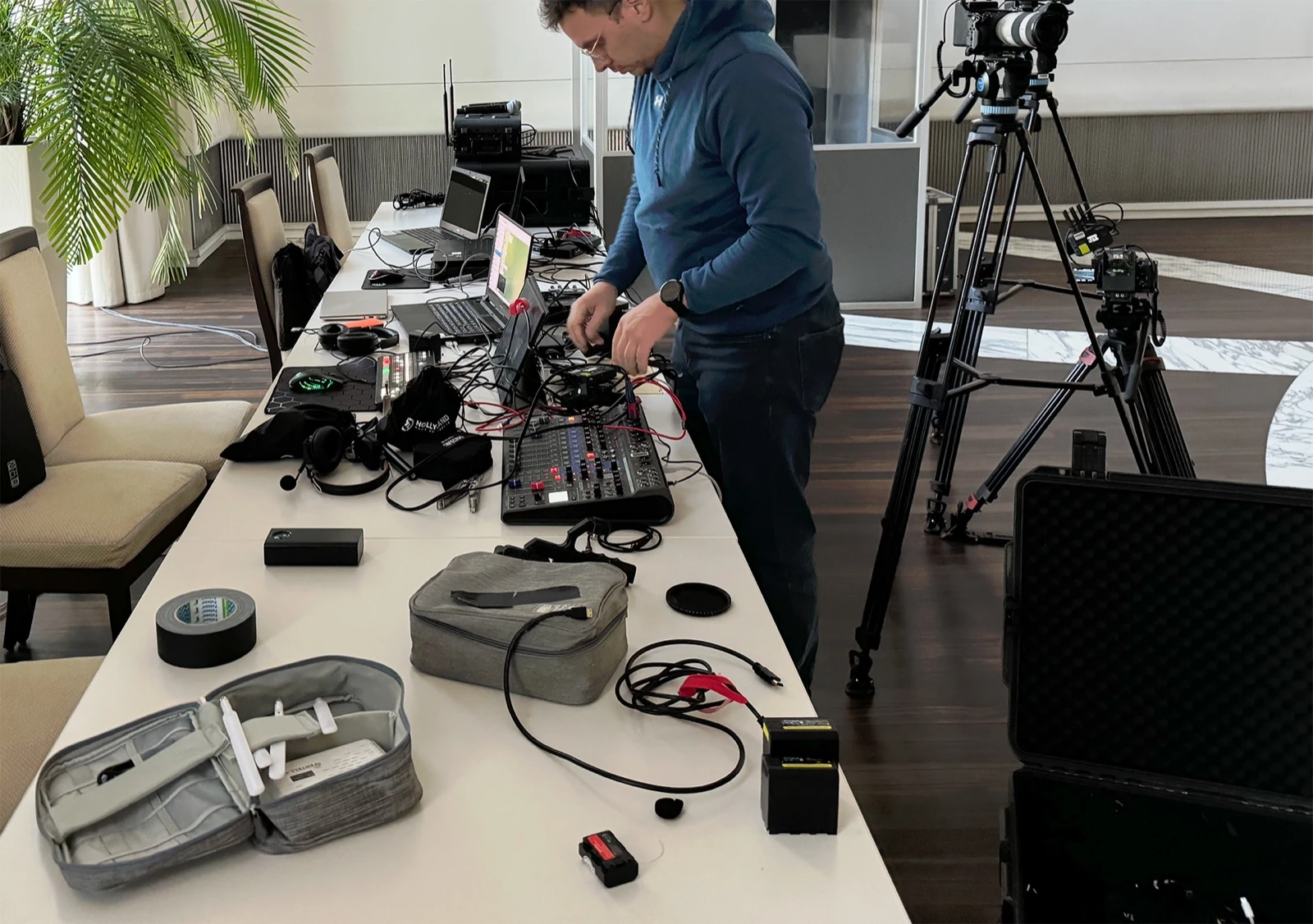 A technician preparing video and sound equipment for a cultural event